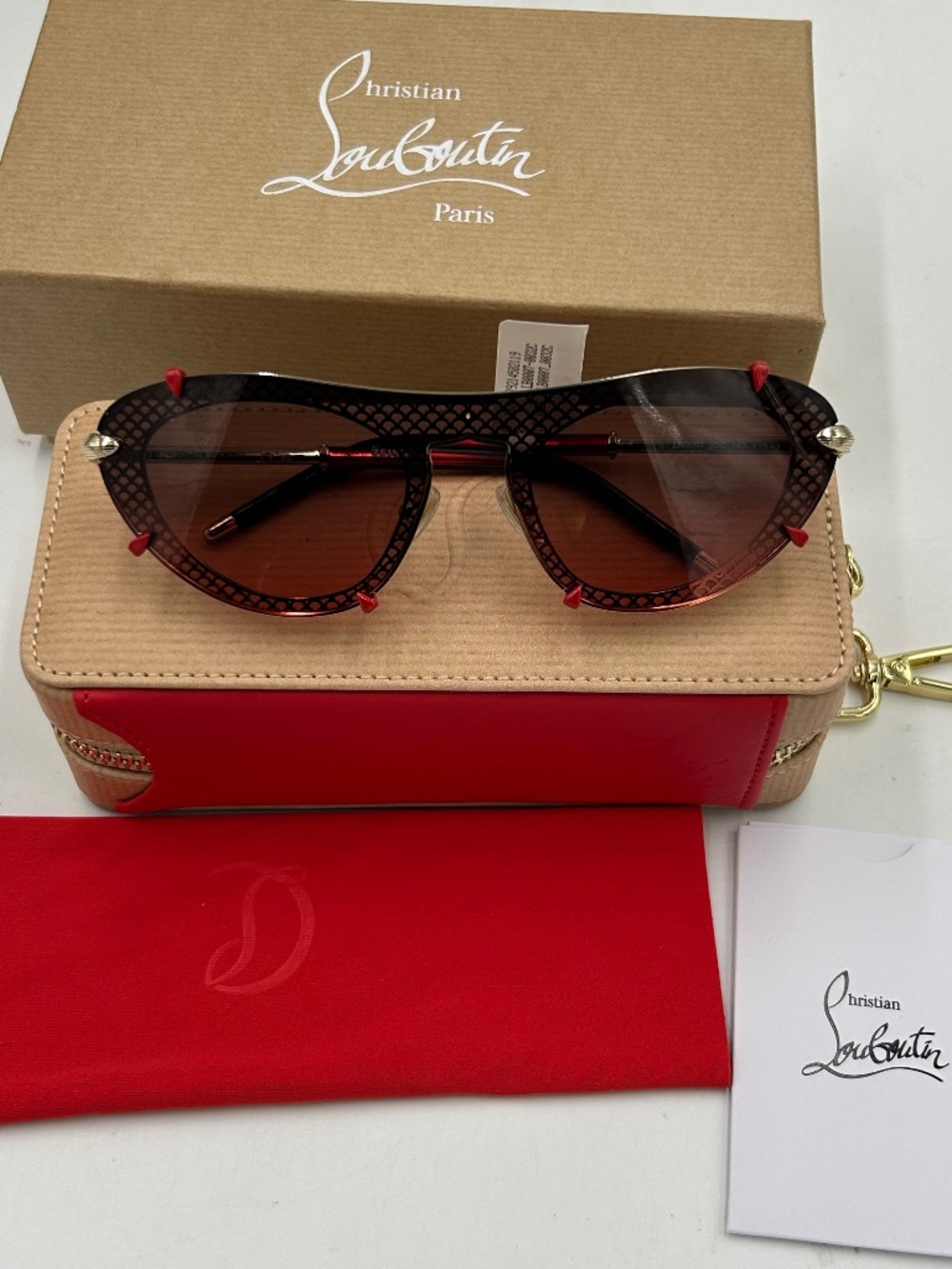 Women’s Christian Louboutin LB0007 gold/smoke metal sunglasses. Made in Italy.